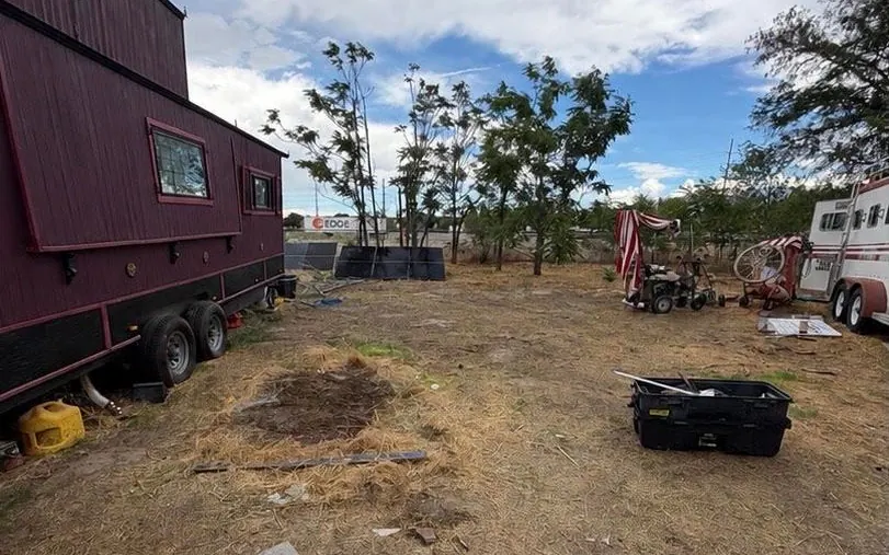 After: the same ground beside the trailer, cleared