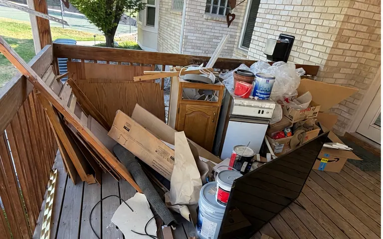 Before: a covered deck stacked with buckets, a cabinet, boxes and trim boards