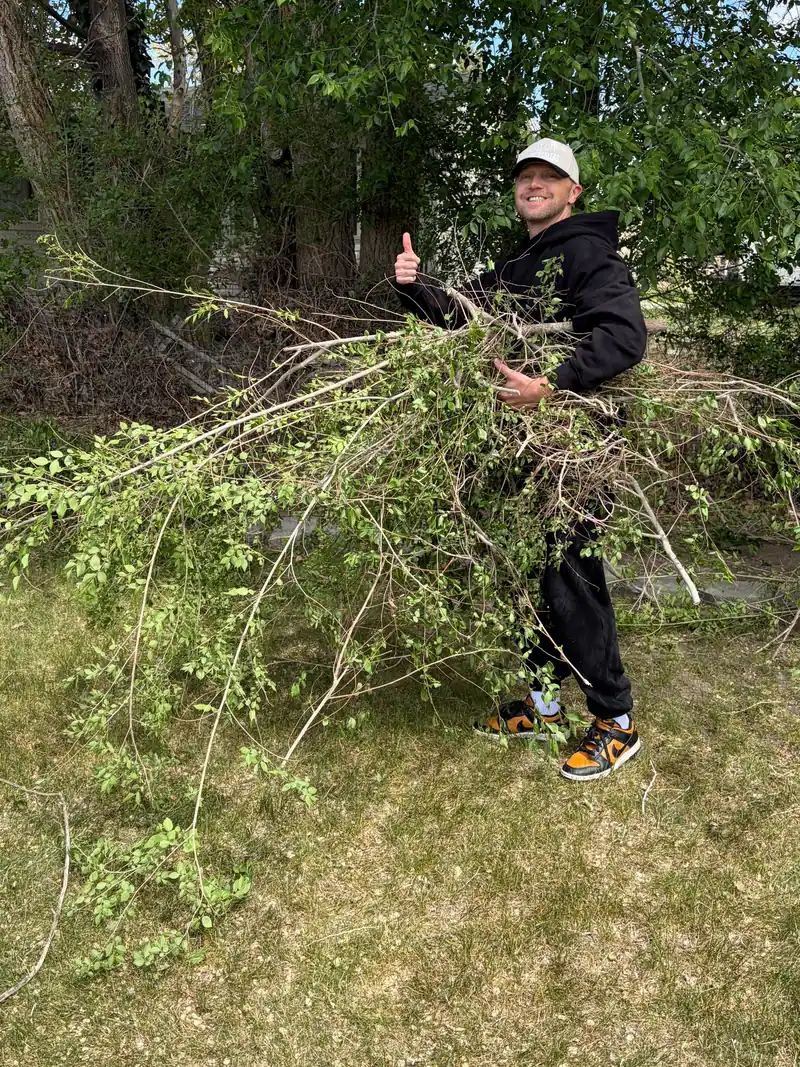 Jeremy carrying branches on a yard debris job