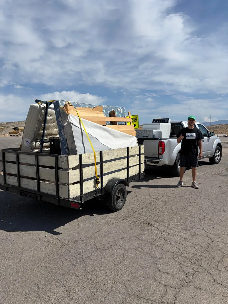 Mattresses, box springs, and an appliance loaded on Jeremy's trailer and truck