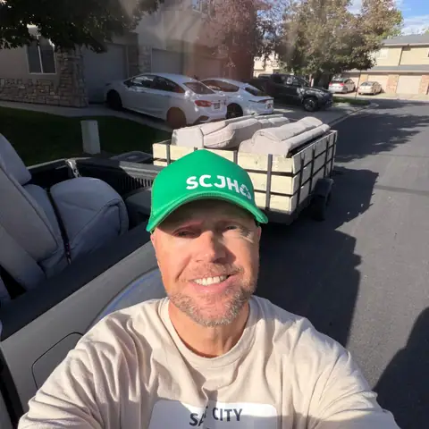 Jeremy in his SCJH cap with the wood-sided trailer behind him