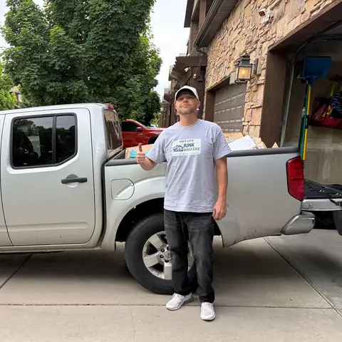 Jeremy standing beside his silver Nissan Frontier pickup